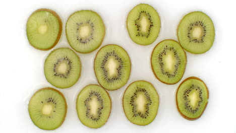 On-a-white-background-sliced-kiwis-are-sprinkled-with-water.-Water-drops-juicy-kiwi.